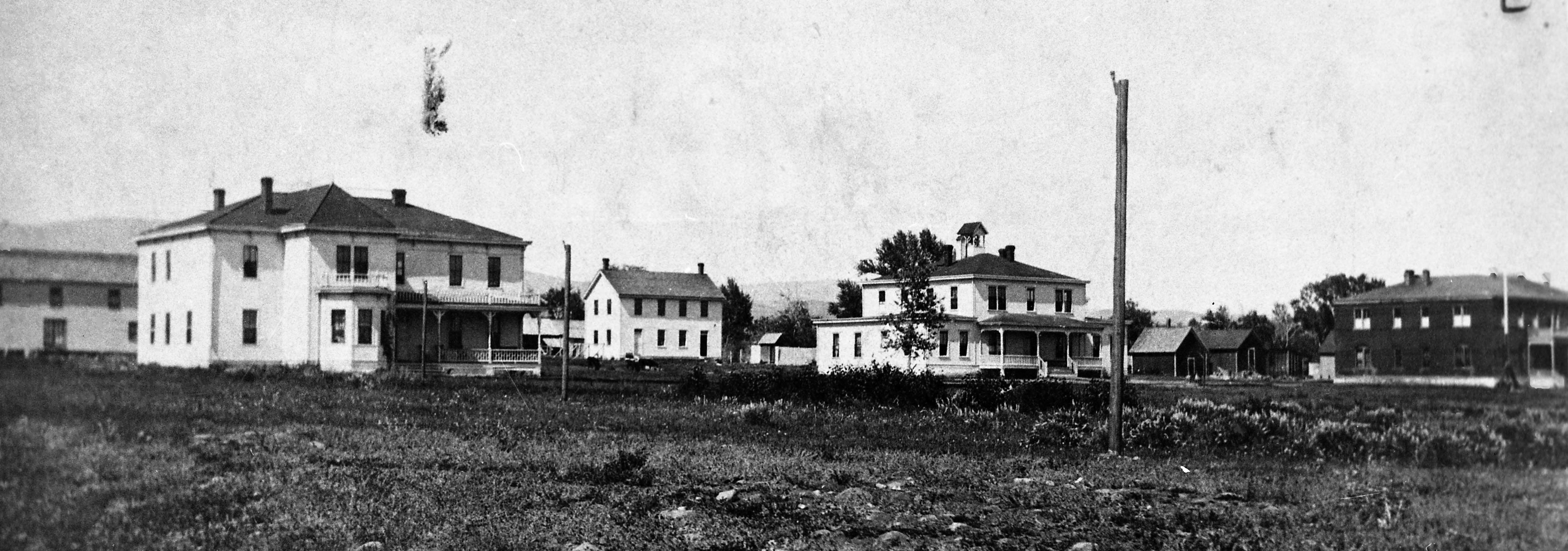 Historical photo of several house-like buildings